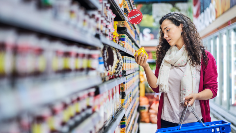 Woman in grocery store shopping for survival food