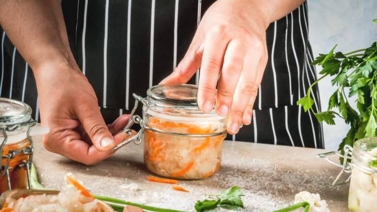 Man canning vegetables for food preservation