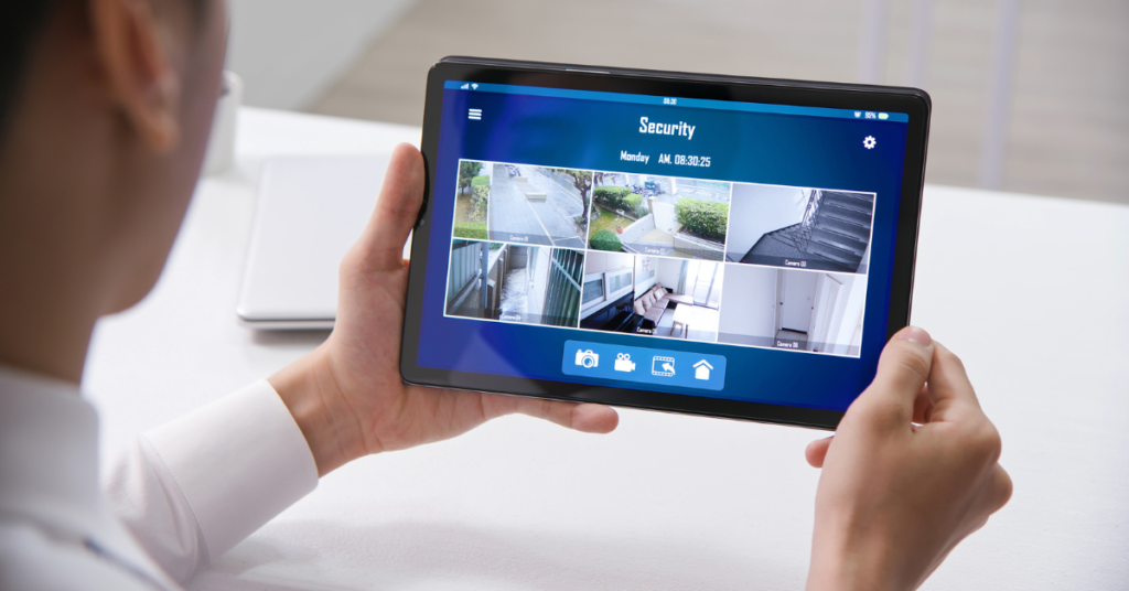 Man checking the cameras on his tablet home security system