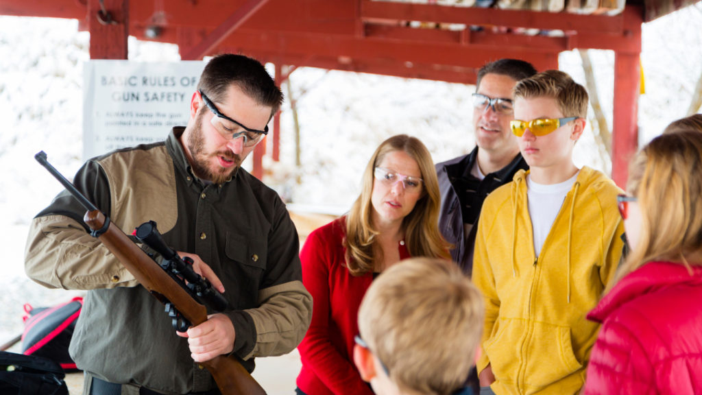 Firerarm instructor teaching family how to handle a gun